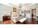 Luxurious main bedroom featuring a large bed and ample natural light at 6337 Rivo Lakes Blvd, Sarasota, FL 34241