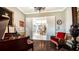 Grand piano and comfortable seating area in a bright music room at 6337 Rivo Lakes Blvd, Sarasota, FL 34241