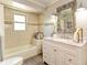 Updated bathroom with a bathtub, granite countertop, and modern fixtures at 6706 22Nd W Ave, Bradenton, FL 34209