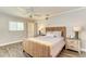 Cozy bedroom with a wicker bed frame and wood-look tile flooring at 6706 22Nd W Ave, Bradenton, FL 34209