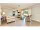 Spacious living room boasts hardwood floors, comfortable seating, and large windows at 6706 22Nd W Ave, Bradenton, FL 34209