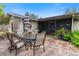 Outdoor patio with seating area, umbrella, and adjacent screened enclosure at 6706 22Nd W Ave, Bradenton, FL 34209