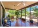 Bright screened porch with tiled floor and comfy seating at 6706 22Nd W Ave, Bradenton, FL 34209