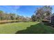 Spacious backyard with pond views and lush landscaping at 7121 Victoria Cir, University Park, FL 34201