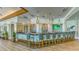 Modern clubhouse bar with stylish seating and a large TV at 7121 Victoria Cir, University Park, FL 34201