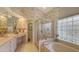 Elegant bathroom with double sinks, shower and bathtub at 7121 Victoria Cir, University Park, FL 34201