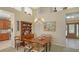 Bright dining room features a wooden table with chairs, a hutch, and access to the kitchen at 7121 Victoria Cir, University Park, FL 34201