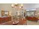 Spacious dining room with wooden table, chandelier, and views into the living room at 7121 Victoria Cir, University Park, FL 34201
