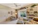 Home office with window seat, built-in shelves, and comfortable armchairs at 7121 Victoria Cir, University Park, FL 34201