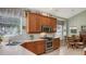 Kitchen boasts wood cabinets, stainless steel appliances, and a breakfast nook at 7121 Victoria Cir, University Park, FL 34201