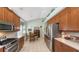 Eat-in kitchen with stainless steel appliances and wood cabinets at 7121 Victoria Cir, University Park, FL 34201