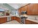Modern kitchen with stainless steel appliances and ample wood cabinetry at 7121 Victoria Cir, University Park, FL 34201