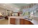 Kitchen with stainless steel appliances, double sink, and views to the living area at 7121 Victoria Cir, University Park, FL 34201