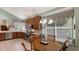 Bright kitchen with wood cabinets, breakfast nook, and large windows at 7121 Victoria Cir, University Park, FL 34201