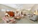 Open living room featuring floral sofas and a wood coffee table at 7121 Victoria Cir, University Park, FL 34201
