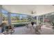 Relaxing screened porch overlooks a pond and lush landscape at 7121 Victoria Cir, University Park, FL 34201