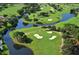Aerial view of lush green golf course with water at 7130 Fairway Bend Ln # 193, Sarasota, FL 34243