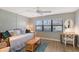 Bright bedroom with a daybed, desk, and window overlooking a golf course at 7130 Fairway Bend Ln # 193, Sarasota, FL 34243