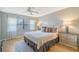 Main bedroom with plush bedding and ceiling fan at 7130 Fairway Bend Ln # 193, Sarasota, FL 34243
