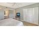 Main bedroom with TV and built-in closet at 7130 Fairway Bend Ln # 193, Sarasota, FL 34243