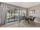 Bright dining area with glass-top table and golf course view at 7130 Fairway Bend Ln # 193, Sarasota, FL 34243