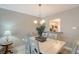 Bright dining room features a farmhouse table and chairs, and a view into the kitchen at 7130 Fairway Bend Ln # 193, Sarasota, FL 34243