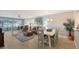 Living room with dining area, hardwood floors, and patio access at 7130 Fairway Bend Ln # 193, Sarasota, FL 34243