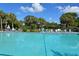 Inviting community pool surrounded by tropical landscaping at 7130 Fairway Bend Ln # 193, Sarasota, FL 34243