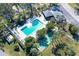 Community pool with shuffleboard and lounge chairs at 7130 Fairway Bend Ln # 193, Sarasota, FL 34243