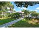 Community pool and clubhouse with lush landscaping at 7130 Fairway Bend Ln # 193, Sarasota, FL 34243