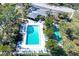 Community pool with surrounding lounge chairs and shuffleboard at 7130 Fairway Bend Ln # 193, Sarasota, FL 34243