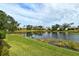Serene backyard view overlooking a tranquil pond at 7160 Rue De Palisades # 4, Sarasota, FL 34238