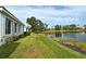 Peaceful backyard with pond view and lush landscaping at 7160 Rue De Palisades # 4, Sarasota, FL 34238
