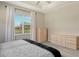 Bedroom with large window, dresser and neutral decor at 7160 Rue De Palisades # 4, Sarasota, FL 34238