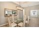 Bright dining room featuring a glass table and chandelier at 7160 Rue De Palisades # 4, Sarasota, FL 34238