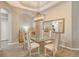 Bright dining room featuring a glass top table and chandelier at 7160 Rue De Palisades # 4, Sarasota, FL 34238
