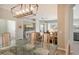 Open concept dining room with glass top table and view into the living room and kitchen at 7160 Rue De Palisades # 4, Sarasota, FL 34238
