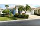 White house with blue shutters, palm trees, and a brick driveway at 7160 Rue De Palisades # 4, Sarasota, FL 34238