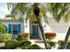 Front entry with teal door, white columns, and lush landscaping at 7160 Rue De Palisades # 4, Sarasota, FL 34238