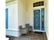 Relaxing front porch with two wicker chairs and a welcome mat at 7160 Rue De Palisades # 4, Sarasota, FL 34238