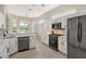 Modern kitchen with white cabinets, stainless steel appliances, and granite countertops at 7160 Rue De Palisades # 4, Sarasota, FL 34238