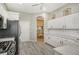 White kitchen with stainless steel appliances and granite countertops at 7160 Rue De Palisades # 4, Sarasota, FL 34238