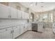 White kitchen with stainless steel appliances and eat-in area at 7160 Rue De Palisades # 4, Sarasota, FL 34238