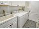 Convenient laundry room with washer, dryer, and utility sink at 7160 Rue De Palisades # 4, Sarasota, FL 34238