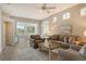 Spacious living room with comfy seating and views to the backyard at 7160 Rue De Palisades # 4, Sarasota, FL 34238