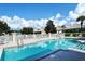Community pool with lounge chairs and surrounding homes at 7160 Rue De Palisades # 4, Sarasota, FL 34238