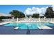 Community pool with surrounding lounge chairs at 7160 Rue De Palisades # 4, Sarasota, FL 34238
