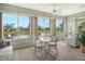 Sunroom with lake views and comfortable seating for relaxation at 7160 Rue De Palisades # 4, Sarasota, FL 34238