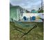 Relaxing backyard with deck, hammock, and colorful seating at 935 Rhodes Ave, Sarasota, FL 34237