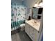 Bathroom with white vanity, tiled floor, and sea-themed decor at 935 Rhodes Ave, Sarasota, FL 34237